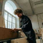 A woodworker working on a piece in his cabinet shop