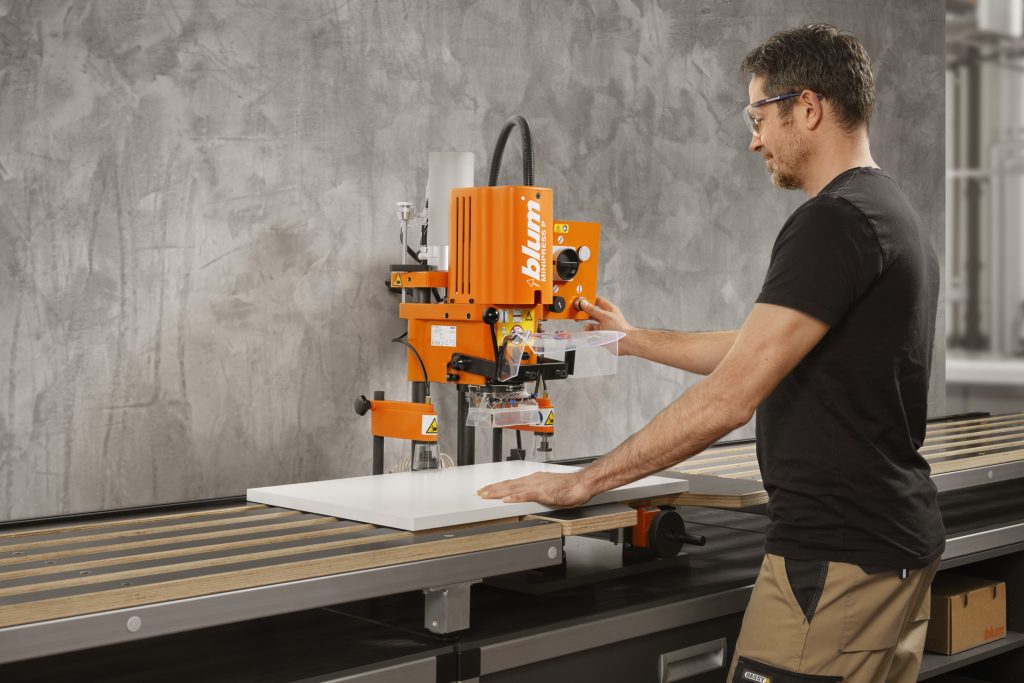 blum-minipress-p - McFaddens Blog Man using a Blum Minipress P in a cabinet shop