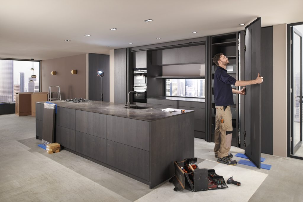 me10479779_all_689035 - McFaddens Blog Man assembling Blum REVEGO uno front in a kitchen